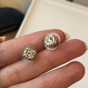 Gold halo stud earrings.